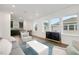 Open-concept living room with modern decor, ample natural light, and a view into kitchen at 9608 Brave Buck Ave, Land O Lakes, FL 34638