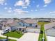 Stunning aerial view of a two-story home with a three-car garage, surrounded by a well-maintained neighborhood at 11728 June Briar Loop, San Antonio, FL 33576