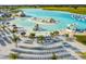 Beautiful lagoon featuring beach chairs, thatched umbrellas, a water slide, and island at 11728 June Briar Loop, San Antonio, FL 33576