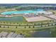 Scenic aerial perspective showcasing a recreational lagoon surrounded by homes and community amenities at 11728 June Briar Loop, San Antonio, FL 33576