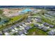 Aerial view of a residential community with lagoon and recreational construction at 11728 June Briar Loop, San Antonio, FL 33576