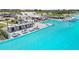Beautiful swimming pool and lounge area with cabanas, chairs, and a building nearby at 11728 June Briar Loop, San Antonio, FL 33576