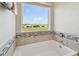 Bathroom with a view of neighboring homes from the large soaking tub window at 11728 June Briar Loop, San Antonio, FL 33576