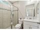 Bathroom featuring glass shower door and white vanity with solid countertop at 11728 June Briar Loop, San Antonio, FL 33576
