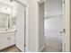 Bathroom view showcasing the vanity, mirror, and doorway leading to the bedroom at 11728 June Briar Loop, San Antonio, FL 33576