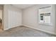 Bedroom featuring closet, neutral walls and carpet, plus a window with natural light at 11728 June Briar Loop, San Antonio, FL 33576
