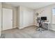 Spacious bedroom featuring a closet, an office space, and a large window allowing natural light at 11728 June Briar Loop, San Antonio, FL 33576
