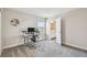 Comfortable bedroom featuring an adjacent bathroom, a dedicated work space, and soft, neutral tones at 11728 June Briar Loop, San Antonio, FL 33576