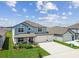 Beautiful two-story home with a three-car garage, manicured lawn, and inviting front entrance at 11728 June Briar Loop, San Antonio, FL 33576