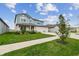 Beautifully landscaped front yard leading to a charming two-story home with a spacious three-car garage at 11728 June Briar Loop, San Antonio, FL 33576
