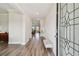 Elegant foyer with hardwood floors, neutral walls, and views into the living area at 11728 June Briar Loop, San Antonio, FL 33576