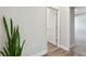 Hallway view showcasing the flooring, neutral paint, and doorway leading to another room at 11728 June Briar Loop, San Antonio, FL 33576
