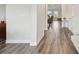 Bright hallway features stylish, light-colored wood floors leading to the living area and bedrooms at 11728 June Briar Loop, San Antonio, FL 33576