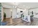 Modern kitchen with white cabinets, island with seating, subway tile backsplash, and stainless steel appliances at 11728 June Briar Loop, San Antonio, FL 33576