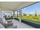 Spacious screened lanai with outdoor seating and a view of the lush green backyard and neighboring homes at 11728 June Briar Loop, San Antonio, FL 33576