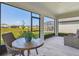 Inviting screened lanai with comfortable seating and tranquil views of the backyard and surrounding neighborhood at 11728 June Briar Loop, San Antonio, FL 33576