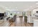 Spacious open-concept living room featuring a kitchen with counter seating, and ample natural light at 11728 June Briar Loop, San Antonio, FL 33576