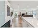 Open-concept living room features wood floors, stairs, and view of Gathering room and kitchen at 11728 June Briar Loop, San Antonio, FL 33576