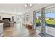 Bright, open living room with wood floors, stylish decor, and sliding glass doors leading to the lanai at 11728 June Briar Loop, San Antonio, FL 33576