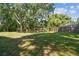 Expansive backyard featuring a wooden playset, offering endless opportunities for outdoor fun and recreation at 17904 Singing Wood Pl, Lutz, FL 33548