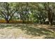Expansive backyard with a secure wooden fence, offering ample privacy and room for outdoor activities at 17904 Singing Wood Pl, Lutz, FL 33548