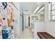 Bathroom featuring a white tiled shower, blue accent wall, and a vanity at 17904 Singing Wood Pl, Lutz, FL 33548