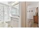 Hall bathroom featuring tiled tub, commode, vanity, and a mirrored medicine cabinet at 17904 Singing Wood Pl, Lutz, FL 33548