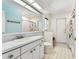 Bright bathroom with a vanity sink, toilet, and a large mirror over the counter at 17904 Singing Wood Pl, Lutz, FL 33548