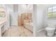 Open bathroom with a glass-enclosed shower and soaking tub at 17904 Singing Wood Pl, Lutz, FL 33548