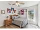 Bright bedroom features a statement wall with decorative artwork and natural light at 17904 Singing Wood Pl, Lutz, FL 33548