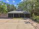 Image of community center with screened in porch, parking and brick paved walkway at 17904 Singing Wood Pl, Lutz, FL 33548