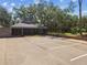 Exterior shot of the community center with parking, screened in porch, and brick paved walkway at 17904 Singing Wood Pl, Lutz, FL 33548
