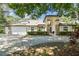 Beautiful home featuring lush landscaping, arched entry, and a spacious three-car garage at 17904 Singing Wood Pl, Lutz, FL 33548