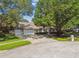 Charming home with well-manicured lawn, a spacious driveway, and a three-car garage at 17904 Singing Wood Pl, Lutz, FL 33548