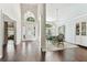 Bright foyer featuring high ceilings, elegant lighting, and a view into the dining area at 17904 Singing Wood Pl, Lutz, FL 33548