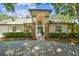 Inviting front entrance featuring an arched entryway and well-maintained landscaping at 17904 Singing Wood Pl, Lutz, FL 33548