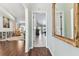Inviting hallway view into a living room featuring hardwood floors and plenty of natural light at 17904 Singing Wood Pl, Lutz, FL 33548