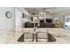 Kitchen sink with granite counters overlooks the Gathering room in an open floor plan at 17904 Singing Wood Pl, Lutz, FL 33548