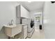 Well-organized laundry room features a utility sink and ample storage space at 17904 Singing Wood Pl, Lutz, FL 33548
