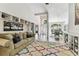 Cozy living room with built-in shelving, large windows, and hardwood floors at 17904 Singing Wood Pl, Lutz, FL 33548