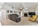 Spacious living room with vaulted ceilings, comfortable seating, and a fireplace at 17904 Singing Wood Pl, Lutz, FL 33548