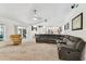 Open concept living room with vaulted ceilings flows into dining area and kitchen at 17904 Singing Wood Pl, Lutz, FL 33548