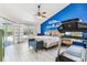 Bedroom with blue accent wall, exercise machine, and patio access to pool views at 17904 Singing Wood Pl, Lutz, FL 33548
