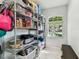 Walk-in pantry with metal shelving and ample space for food and household storage at 17904 Singing Wood Pl, Lutz, FL 33548
