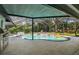 Screened-in pool and backyard with an elegant pool design and lush landscaping at 17904 Singing Wood Pl, Lutz, FL 33548