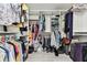 Spacious walk-in closet with custom shelving and rods for ample storage at 17904 Singing Wood Pl, Lutz, FL 33548
