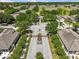 Aerial view of a gated community entrance with tree lined streets and manicured landscaping at 14820 Potterton Cir, Hudson, FL 34667