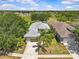 Stunning aerial view of a home featuring a well-manicured lawn and a two-car garage at 14820 Potterton Cir, Hudson, FL 34667