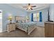 Charming bedroom with blue walls, tray ceilings, and coastal decor and a ceiling fan at 14820 Potterton Cir, Hudson, FL 34667
