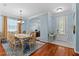 Formal dining room featuring hardwood floors, elegant chandelier, and abundant natural light at 14820 Potterton Cir, Hudson, FL 34667